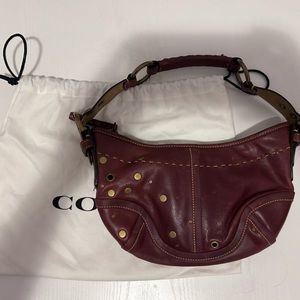 Coach leather shoulder bag with grommets.